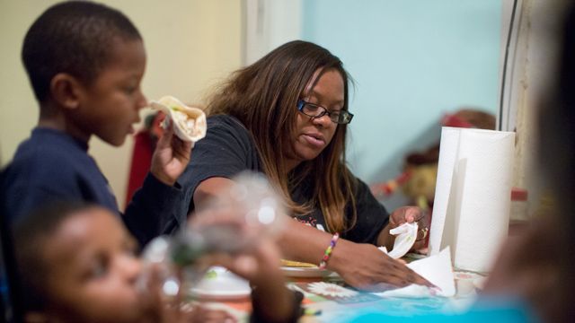 Jennifer Donald whose family receives money from the Supplemental Nutrition Assistance Program also know as food stamps, eats dinner with her sons David, 6, left, and Donovan, 4, in Philadelphia. (AP Photo/Matt Rourke)
