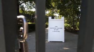 A "closed" sign is seen through the locked iron gate of the National Gallery of Art Sculpture Garden in Washington, Wednesday, Oct. 2, 2013. (AP Photo/Carolyn Kaster)