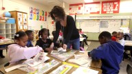 Teacher Lori Peck, helps first grader Timia Harris at Grace L. Patterson Elementary school in Vallejo, Calif. (AP Photo/Rich Pedroncelli)