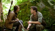 Jennifer Lawrence portrays Katniss Everdeen, left, and Liam Hemsworth portrays Gale Hawthorne in a scene from 'The Hunger Games.' (AP Photo/Lionsgate, Murray Close, File)