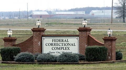 A hazy view of the Yazoo City Federal Corrections Complex can be seen in the background of its front gate. (AP Photo/Rogelio V. Solis, File)