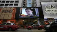 A TV screen shows a news report of Edward Snowden at a shopping mall in Hong Kong Sunday, June 23, 2013. (AP Photo/Vincent Yu, File)