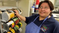 School food service worker Alina Mendoza stands in the kitchen of Scott Elementary School in Topeka, Kan. (AP Photo/Orlin Wagner)
