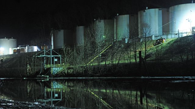 Crews clean up a chemical spill along the Elk River in Charleston, W.Va., which compromised the public water supply of eight counties on Thursday, Jan. 9, 2014. (AP Photo/Tyler Evert)