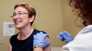 Linda Potter, left, receives a shot of H1N1 flu vaccine from a research nurse during the first of several clinical trials of a new vaccine conducted by Emory University, Mon., August 10, 2009, in Atlanta. (AP Photo/John Amis)