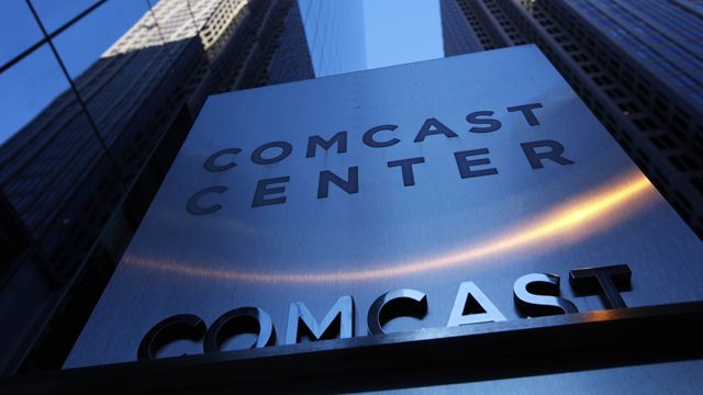 In this Dec. 3, 2009 file photo, a sign outside the Comcast Center, left, is shown in Philadelphia. (AP Photo/Matt Rourke, file)