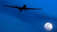 In this Jan. 31, 2010 file photo, an unmanned U.S. Predator drone flies over Kandahar Air Field, southern Afghanistan, on a moon-lit night. (AP Photo/Kirsty Wigglesworth, File)