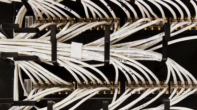 This undated photo made available by Google shows the Internet wiring at Google's data center in Berkley County, S.C. The fiber optic networks connecting the company's sites can run at speeds that are more than 200,000 times faster than a typical home Internet connection. (AP Photo/Google, Connie Zhou)