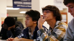 EMBARGOED FOR RELEASE AT 3 A.M. EST (5 P.M. JST) -  Students Julian Lopez, 12th grade, second left; Ben Montalbano, 11th grade, second right; and James Agostino, 12th grade, right; listen during their Advanced Placement (AP) Physics class at Woodrow Wilson High School in Washington, Friday, Feb. 7, 2014. (AP Photo/Charles Dharapak)