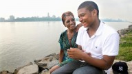 Rachel Noerdlinger and her son Khari, 14, sit at the edge of the Hudson River near their home in Edgewater, N.J., on Tuesday, June 28, 2011. (AP Photo/Bebeto Matthews)