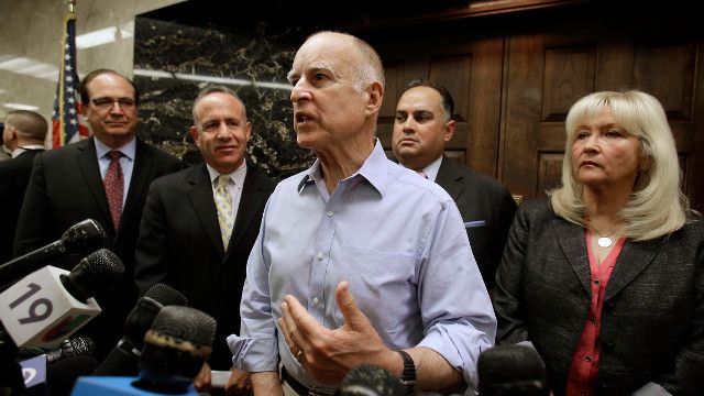Gov. Jerry Brown, center, responds to a question during a Capitol news conference in Sacramento, Calif., Monday, Sept. 9, 2013. (AP Photo/Rich Pedroncelli)