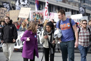 Aly Johnson-Kurts, left, a Vermont coordinator with 350.org, speaks with other protest organizers as students march toward the White House. (Photo: John Light)