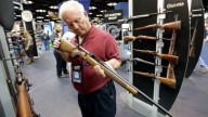 Jerry Miller, of Georgetown, Texas, looks over a rifle at the National Rifle Association's annual convention on Friday, April 25, 2014 in Indianapolis. (AP Photo/AJ Mast)