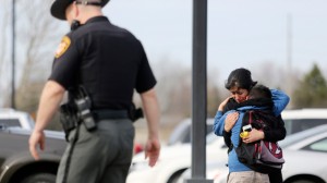 Students and parents are reunited after a lock down in response to a shooting in the parking lot of Liberty Elementary, just minutes before the students there were to be dismissed, Thursday, April 10, 2014 in Columbus, Ohio. (AP Photo/Columbus Dispatch, Courtney Hergesheimer)