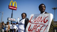Josh Adams, right, chants with other protestors near the corner of Airways Blvd. and Lamar Ave. outside of a McDonalds in Memphis, Tenn. Thursday, May 15, 2014, while demonstrating for a $15 wage and right to form a union without retaliation in the fast food industry. (AP Photo/The Commercial Appeal, William DeShazer)