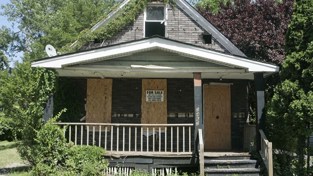 In this photo taken on Tuesday, July 14, 2009, a "For Sale" sign rests on a vacant house in Cleveland. (AP Photo/Tony Dejak)