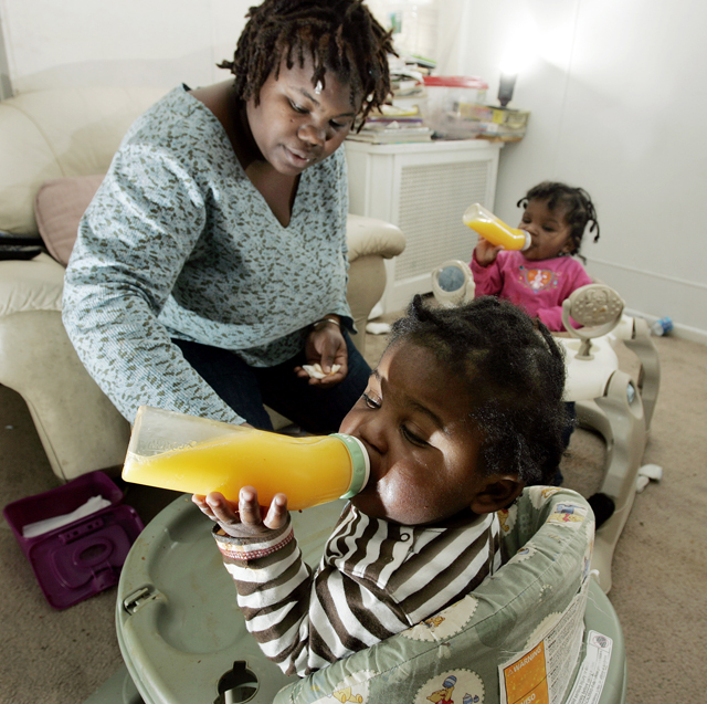 Tianna Gaines-Turner watches as her twin toddlers Marques, left, and Marianna Turner (at the time, both only 1 year old) have juice, Feb. 26, 2009, at their home in Philadelphia, PA. (AP Photo/Mel Evans)