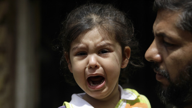 A girl whose mother was killed in a U.S. military raid cries as she is consoled by a relative in front of her house in Kut, 160 kilometers (100 miles) southeast of Baghdad, Iraq, Monday, April 27, 2009. (AP Photo/Khalid Mohammed)