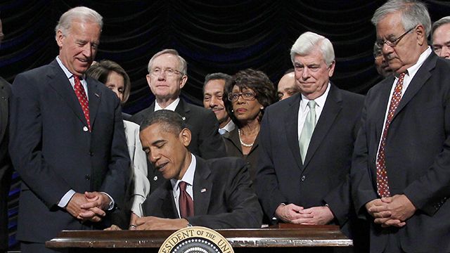 President Barack Obama, center, signs the Dodd Frank-Wall Street Reform and Consumer Protection Act in a ceremony in the Ronald Reagan Building in Washington, Wednesday, July 21, 2010.(AP Photo/Pablo Martinez Monsivais)