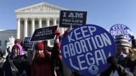 Pro-abortion and anti-abortion protestors rally outside the Supreme Court in Washington, Wednesday, Jan. 22, 2014. Thousands of abortion opponents are facing wind chills in the single digits to rally and march on Capitol Hill to protest legalized abortion, with a signal of support from Pope Francis. (AP Photo/Susan Walsh)