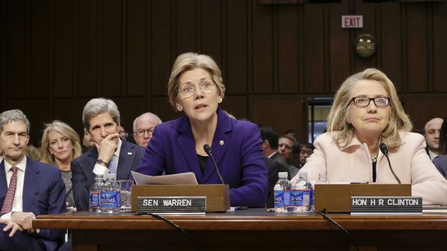 Sen. Elizabeth Warren, D-Mass., center, accompanied by Secretary of State Hillary Rodham Clinton, right, make statements introducing Senate Foreign Relations Chairman Sen. John Kerry, D-Mass., seated at left, to the committee during his confirmation hearing to become secretary of state, replacing Clinton, Thursday, Jan. 24, 2013, on Capitol Hill in Washington. (AP Photo/J. Scott Applewhite)