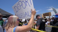 A demonstrator that opposes illegal immigration, left, shouts at immigration supporters, Friday, July 4, 2014, outside a U.S. Border Patrol station in Murrieta, Calif. Demonstrators on both sides of the immigration debate had gathered where the agency was foiled earlier this week in an attempt to bus in and process some of the immigrants who have flooded the Texas border with Mexico. (AP Photo/Mark J. Terrill)