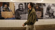 New Yorker Vince Verdi walks past a display of photographs of homeless people displayed below ground at the West 4th Street subway station in New York, Wednesday, May 21, 2014. Serrano's images of the cityÃ­s marginalized residents also are plastered inside 50 phone booths and bus stop shelters around Manhattan. Ã¬Resident of New YorkÃ® is SerranoÃ­s first public art project, and it runs through June 15. (AP Photo/Kathy Willens)