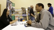 Job seeker US Air Force veteran Jesse Jefferson, Jr., right, talks to Arianna Alexander, of the Pompano Beach Veterans Center, at a Hiring Fair For Veterans in Fort Lauderdale, Florida. (AP Photo/Alan Diaz)