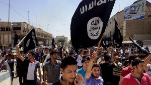 Demonstrators chant pro-al-Qaida-inspired Islamic State of Iraq and the Levant (ISIL) as they carry al-Qaida flags in front of the provincial government headquarters in Mosul, 225 miles (360 kilometers) northwest of Baghdad, Iraq, Monday, June 16, 2014. (AP Photo)