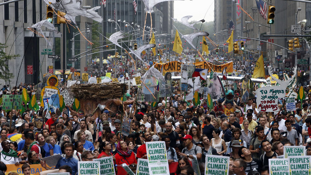 Demonstrators make their way down Sixth Avenue in New York during the People's Climate March Sunday, Sept. 21, 2014. The march, along with similar gatherings scheduled in other cities worldwide, comes two days before the United Nations Climate Summit, where more than 120 world leaders will convene for a meeting aimed at galvanizing political will for a new global climate treaty by the end of 2015. (AP Photo/Jason DeCrow)