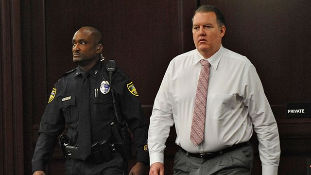 Defendant Michael Dunn re-enters the courtroom as the jury had a question shortly after deliberations began during his retrial on Wednesday, Oct. 1, 2014 in Jacksonville, Fla. Dunn is being retried on murder charges for the shooting death of 17-year old Jordan Davis in a dispute over loud music at a Jacksonville gas station in November of 2012. Dunn was found guilty of three counts of attempted murder and one count of shooting or throwing a deadly missile during his previous trial, but the jury was deadlocked on the murder charge. (AP Photo/The Florida Times-Union, Bob Mack, Pool)