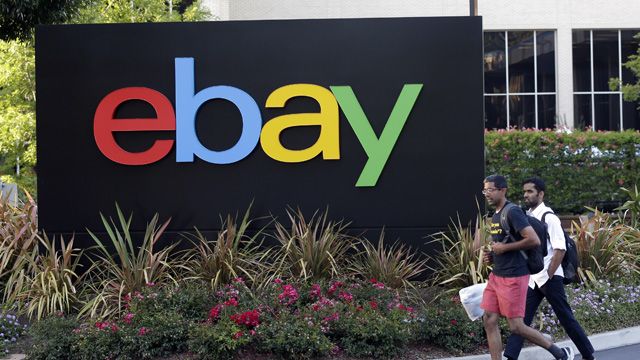 In this June 5, 2014 photo, people walk in front of an eBay Inc. sign at the company's headquarters in San Jose, Calif. EBay Inc. reports quarterly financial results on Wednesday, July 16, 2014. (AP Photo/Marcio Jose Sanchez)
