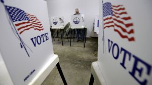 Bow Stanley, from Silver Lake, Kansas, votes at the Prairie Home Cemetery building, Tuesday, November 4, 2014, in Topeka, Kansas. (AP Photo/Charlie Riedel)