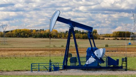An oilfield pumpjack works pumping crude on an oil well, belonging to ConocoPhillips, near Condor Alberta on Oct. 1, 2014. (AP Photo/Larry MacDougal)