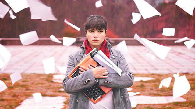 A 20-something woman embracing a typewriter. (Photo: Christian Gonzalez/flickr CC 2.0)