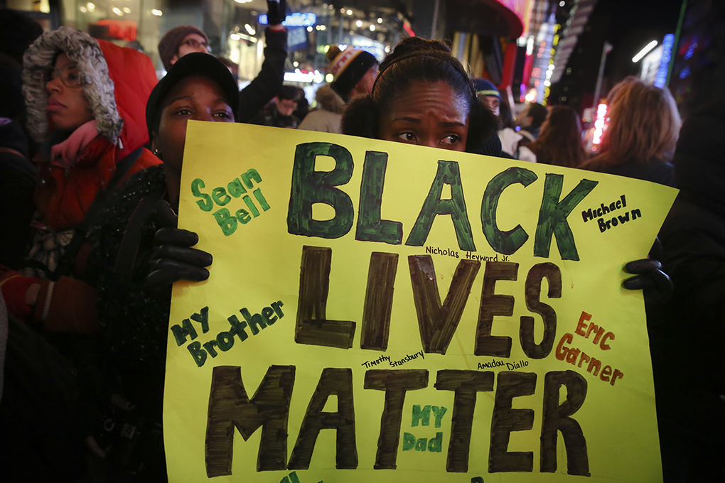 Protestors march against a grand jury's decision not to indict the police officer involved in the death of Eric Garner, Thursday, Dec. 4, 2014, in New York. A grand jury cleared a white New York City police officer Wednesday in the videotaped chokehold death of Garner, an unarmed black man, who had been stopped on suspicion of selling loose, untaxed cigarettes, a lawyer for the victim's family said. (AP Photo/John Minchillo)