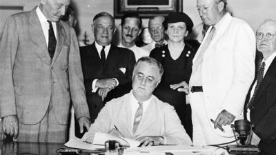 FDR signs social security act in 1935