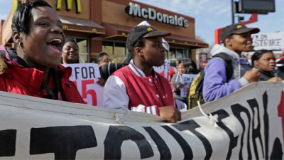 McDonald's workers and supporters rally outside a McDonald's, Wednesday, April 15, 2015, in Chicago. Fast-food workers calling for $15 an hour are picking up some more allies Wednesday. Airport workers, home care workers, Walmart workers and adjunct professors are among those set to join in the fight for $15 protests across the country, in what organizers are calling the biggest ever mobilization of workers in the U.S. (AP Photo/M. Spencer Green)