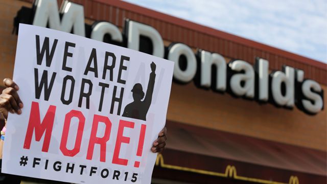 McDonald's workers and supporters rally outside a McDonald's, Wednesday, April 15, 2015, in Chicago. Fast-food workers calling for $15 an hour are picking up some more allies Wednesday. Airport workers, home care workers, Walmart workers and adjunct professors are among those set to join in the fight for $15 protests across the country, in what organizers are calling the biggest ever mobilization of workers in the U.S. (AP Photo/M. Spencer Green)