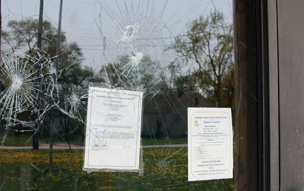 The smashed glass of the front entrance of Martin Luther King Jr. Elementary School, which closed after students fled the charter school district. (Photo by Eduardo García)