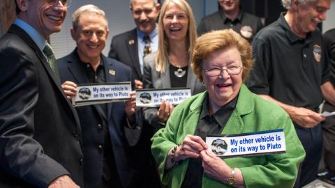 Sen. Barbara Mikulski, D-Md. holds a bumper sticker given to her by members of the New Horizons team at the Johns Hopkins University Applied Physics Laboratory (APL) Monday, July 13, 2015 at APL in Laurel, Maryland.