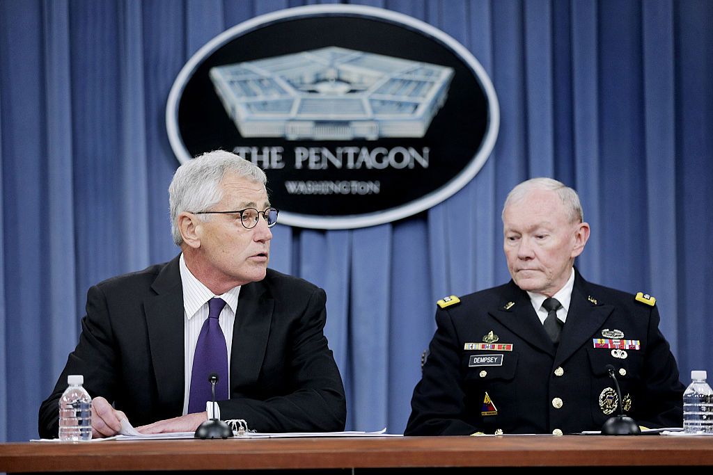 ARLINGTON, VA - SEPTEMBER 26:  Secretary of Defense Chuck Hagel, left, and Joint Chiefs of Staff Chairman General Martin Dempsey speak to the press about the ongoing bombing campaign against militants in Iraq and Syria during a news conference at the Pentagon on September 26, 2014 in Arlington, Virginia. The president authorized the air support as part of a coalition with both western nations and some nations in the Middle East.  (Photo by T.J. Kirkpatrick/Getty Images)
