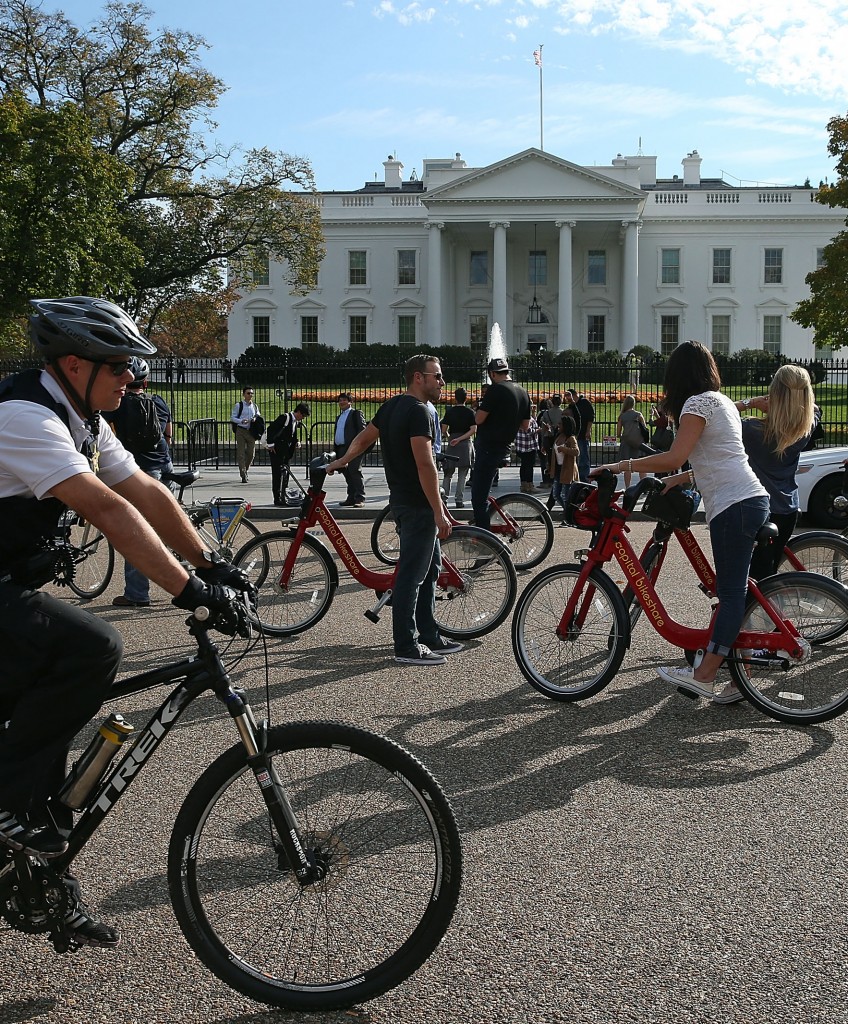 WASHINGTON, DC - NOVEMBER 06: A U.S. Secret Service officer (L) patrols on a bicycle as tourist sight see on a unseasonably warm fall day in front of the White House, November 6, 2015 in Washington, DC. Todays temperature in Washington reached 79 degrees breaking the record of 78 degrees. The last time Washington reached 80 was in November was November 5, 2003. (Photo by Mark Wilson/Getty Images)