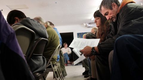 BILOXI, MS - JANUARY 03: Men and women participate in a church service before a meal at the Seashore Miss. (Photo by Spencer Platt/Getty Images)
