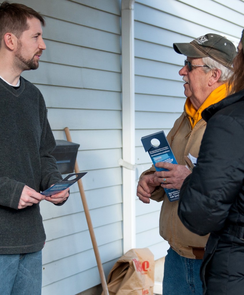 Volunteers for Democratic presidential candidate Bernie Sanders speak with a local resident while canvasing neighborhoods on January 31, 2016 in Fort Madison, Iowa, one day before the state's much anticipated February 1st caucus. US presidential candidates made a frenzied, final push to lock in Iowa voters on the eve of the first nominating contest of the 2016 election season. / AFP / Michael B. Thomas (Photo credit should read MICHAEL B. THOMAS/AFP/Getty Images)