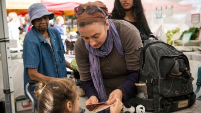 A woman and her daughter counts out Electronic Benefits Transfer (EBT) coupons, more commonly known as Food Stamps, while shopping for groceries in the GrowNYC Greenmarket in Union Square. (Photo by Andrew Burton/Getty Images)