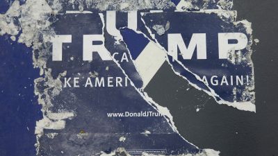 Discarded campaign posters are stuck to the floor following a rally with Republican presidential candidate Donald Trump at Macomb Community College on March 4, 2016 in Warren, Michigan. Voters in Michigan will go to the polls March 8 for the State's primary. (Photo by Scott Olson/Getty Images)