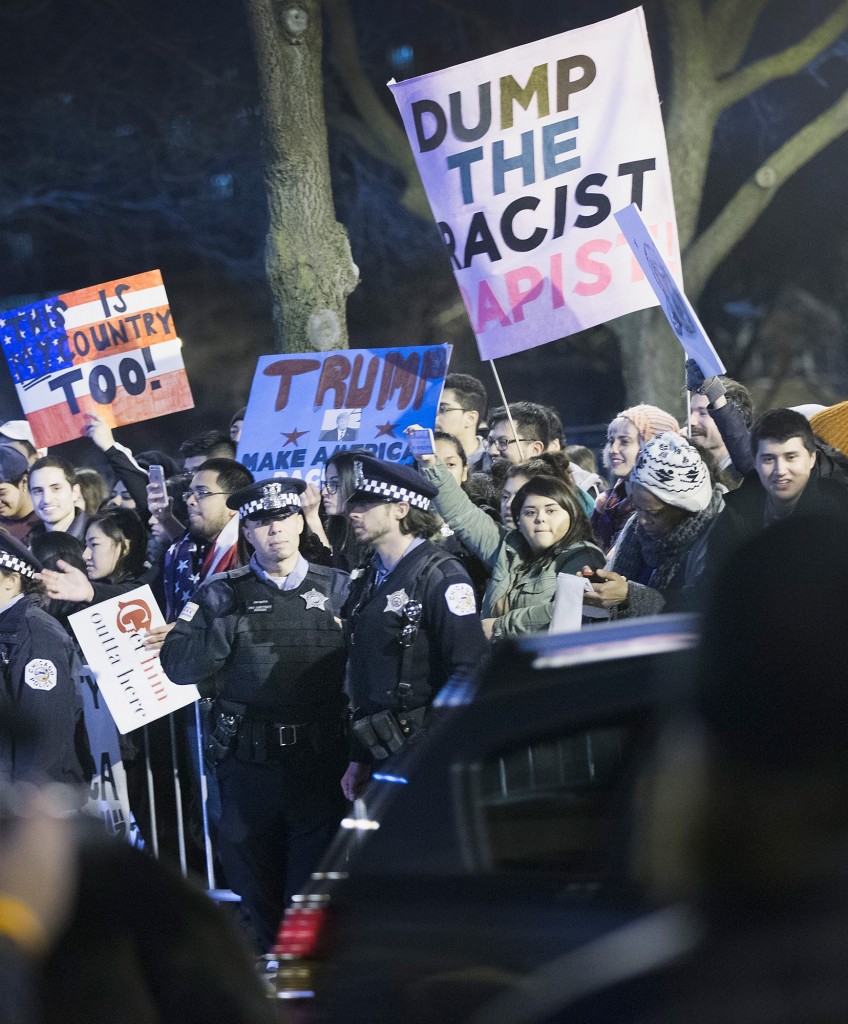 CHICAGO, IL - MARCH 11: Demonstrators taunt supporters of Republican presidential candidate Donald Trump as they leave a rally at the University of Illinois at Chicago which was postponed on March 11, 2016 in Chicago, Illinois. Organizers postponed the rally citing safety reasons after hundreds of demonstrators were ticketed for the event. (Photo by Scott Olson/Getty Images)