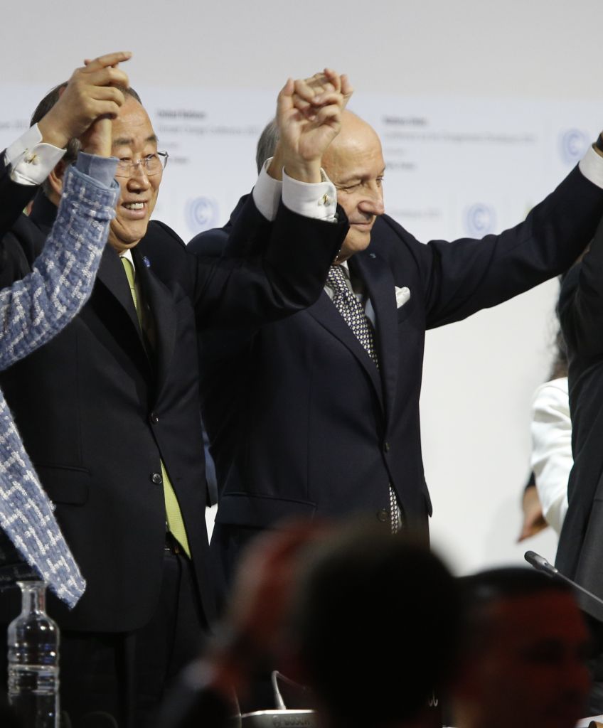TOPSHOT - In this picture taken on December 12, 2015 Foreign Affairs Minister and President-designate of COP21 Laurent Fabius (C), raises hands with Secretary General of the United Nations Ban Ki Moon (2-L) and France's President Francois Hollande (R) after adoption of a historic global warming pact at the COP21 Climate Conference in Le Bourget, north of Paris. / AFP / FRANCOIS GUILLOT (Photo credit should read FRANCOIS GUILLOT/AFP/Getty Images)