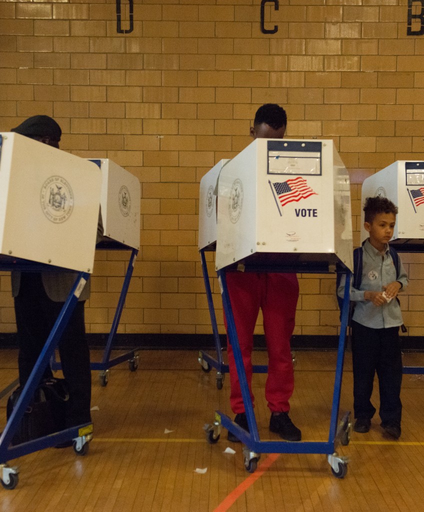 NEW YORK, NY - APRIL 19: A man with his son votes at Public School 22 on April 19, 2016 in the Brooklyn borough of New York City. Voters are going to the polls in New York for the presidential primary election. (Photo by Stephanie Keith/Getty Images)